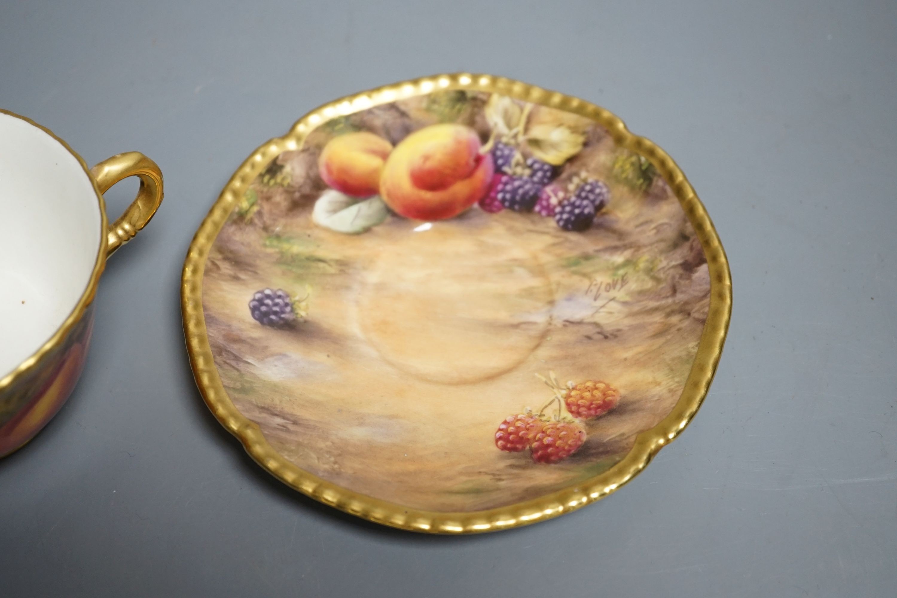 A Royal Worcester fruit painted large tea cup and saucer, signed P. Love, height 7cm overall